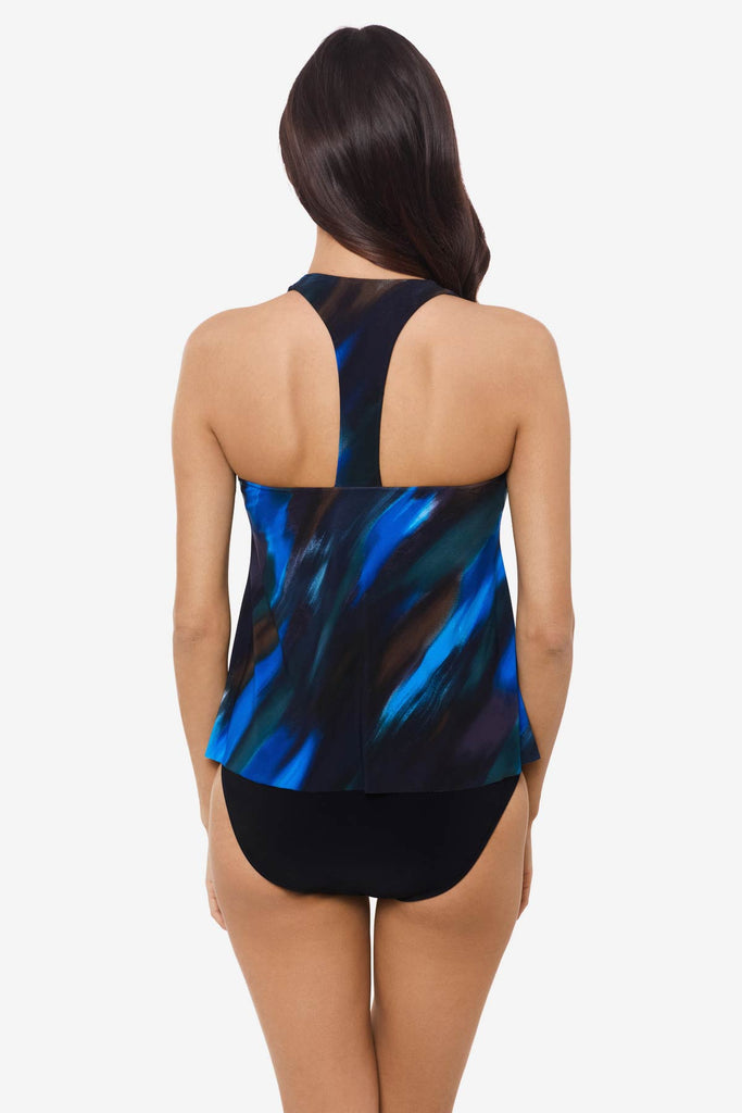 Woman facing away wearing a multicolor tankini top with an abstract print