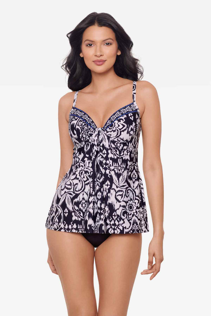 Woman wearing a blue and white tankini top with abstract flowers