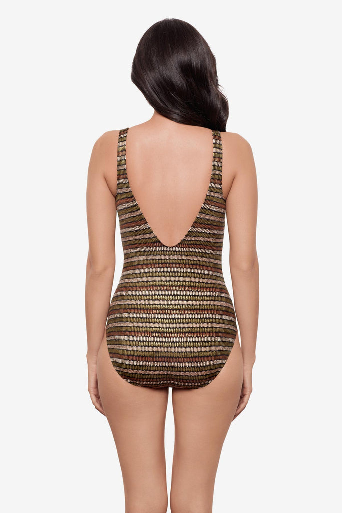 Woman turned away wearing a shimmery golden brown striped one-piece swimsuit 