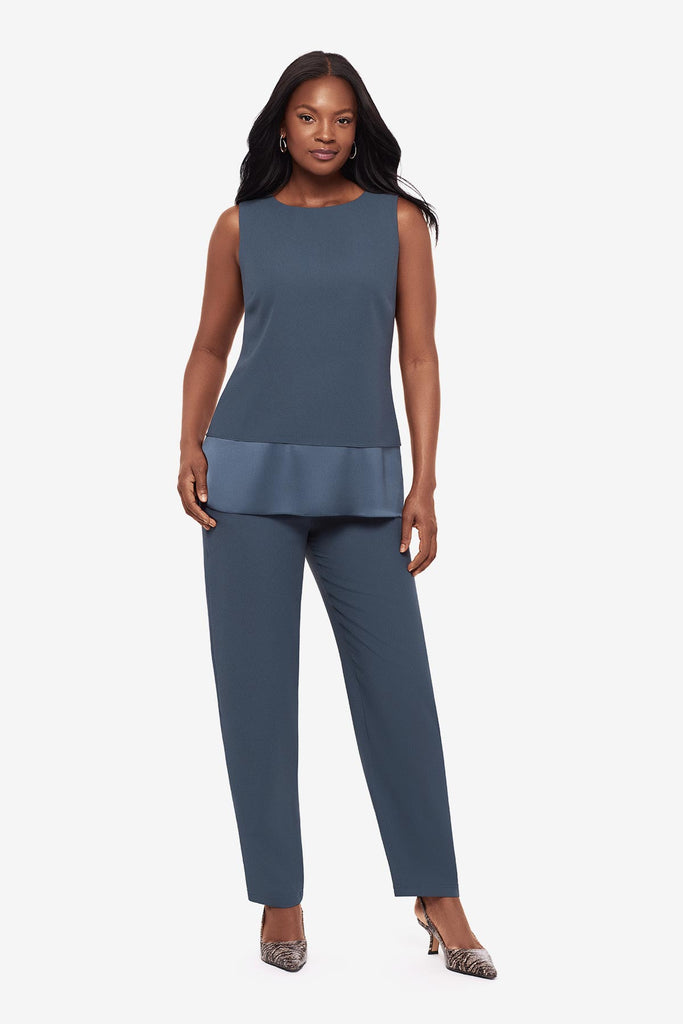 Woman wearing a blue layered tunic blouse with matching jogger pants