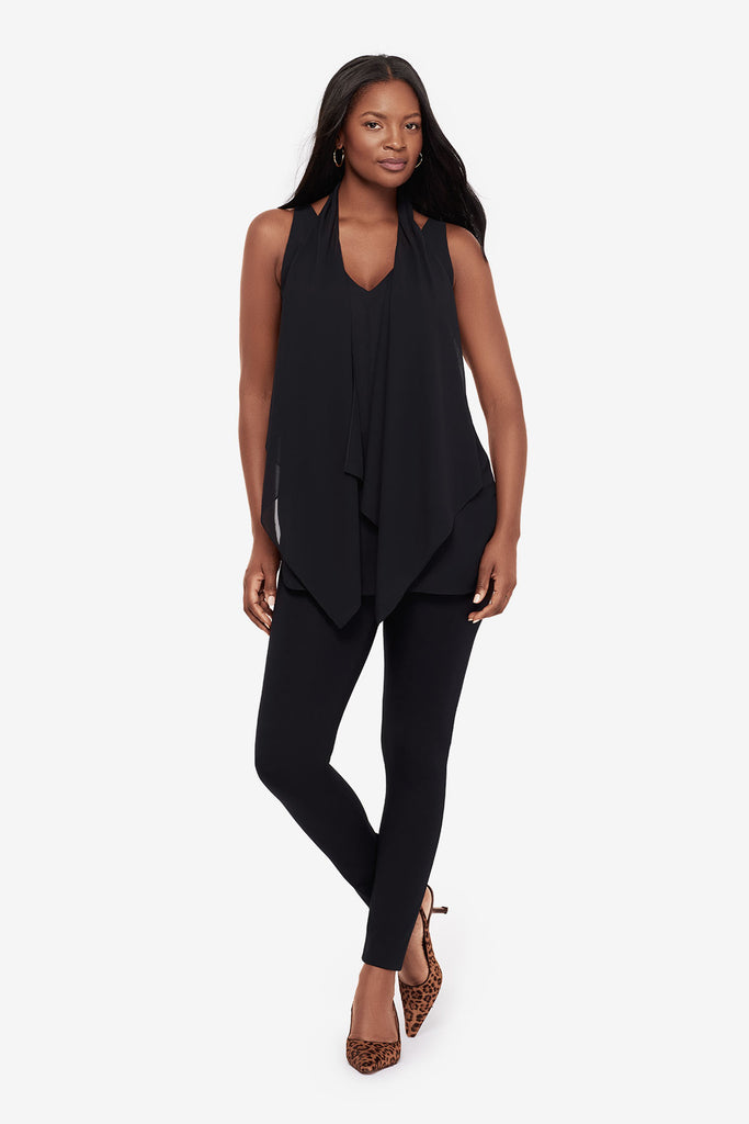 Woman wearing a black layered tunic blouse with matching leggings