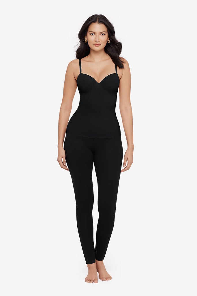 Woman wearing a black cupped bra cami top with matching black leggings