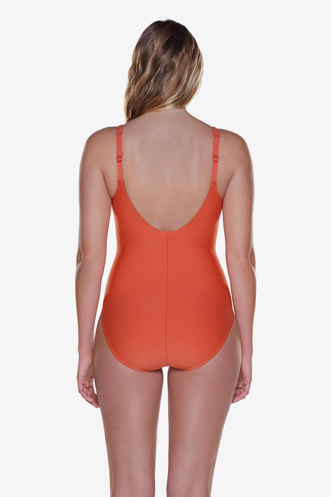 Woman turned away wearing a solid orange one-piece swimsuit