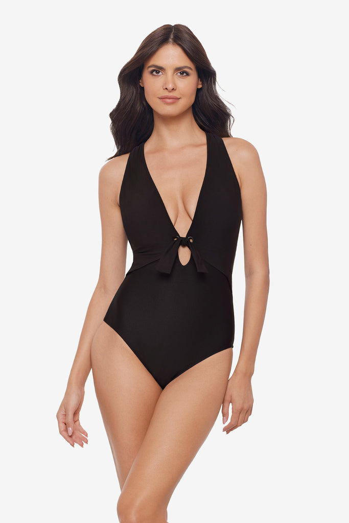 Woman wearing a black one-piece swimsuit with a deep V neck