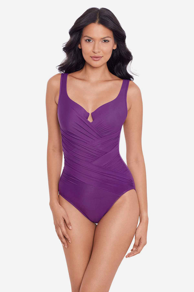 Woman wearing a purple one-piece swimsuit with a sweetheart neckline